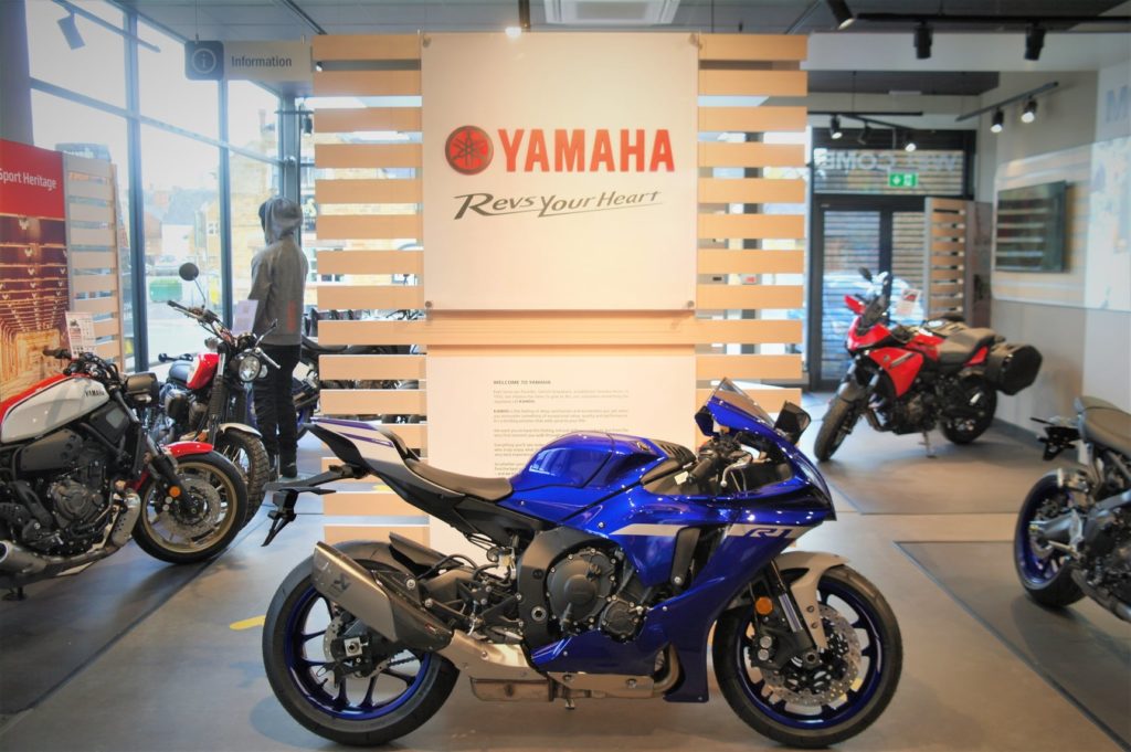 Motorcycle under Yamaha logo in showroom