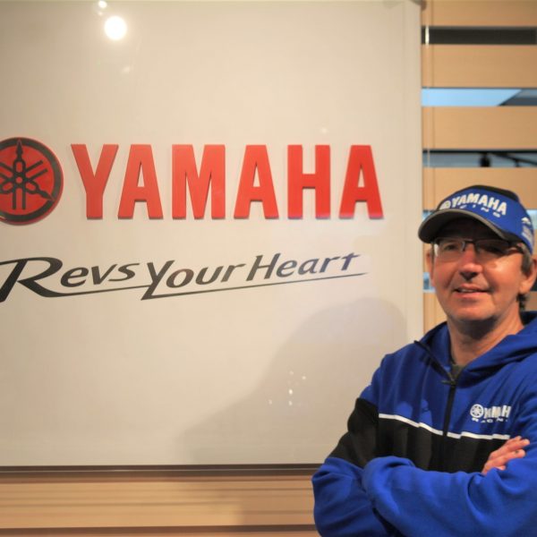 Man stood next to Yamaha logo Dave