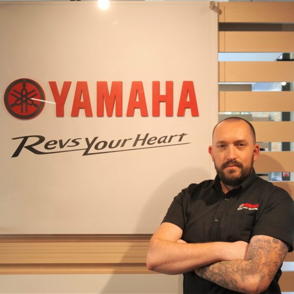 Man stood next to Yamaha logo James